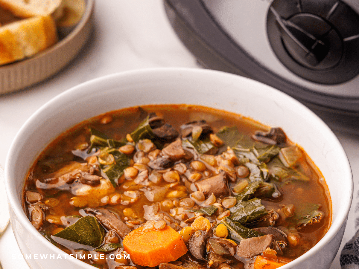 bowl of Lentil Soup next to a crock pot
