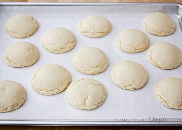 fully baked sugar cookies on a baking sheet using this easy 10 minute recipe