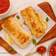 finished Caprese Calzones on a wood cutting board