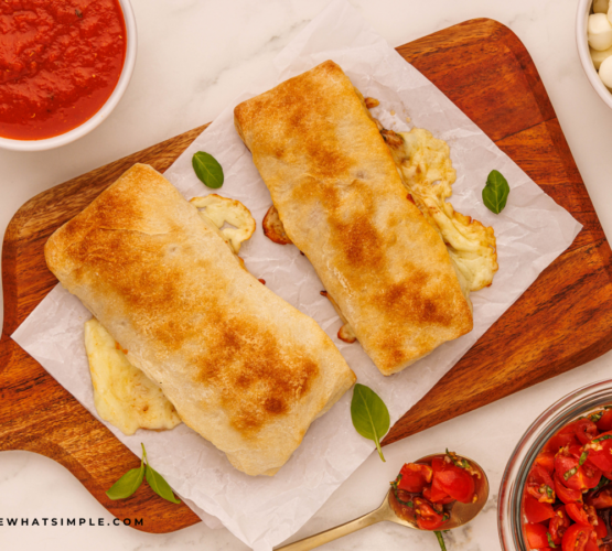 finished Caprese Calzones on a wood cutting board