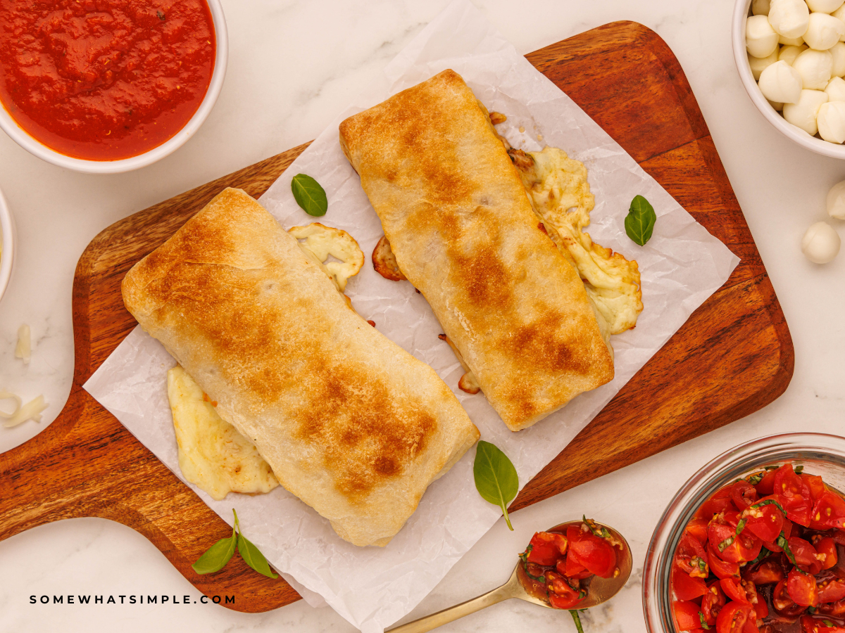 finished Caprese Calzones on a wood cutting board