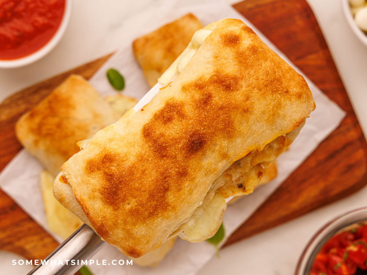 close up of a Caprese Calzone on a serving spatula