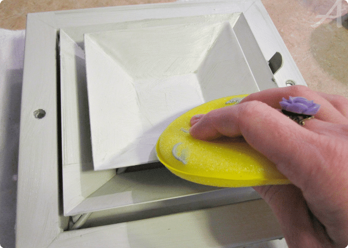 using a waxing sponge to clean an air vent