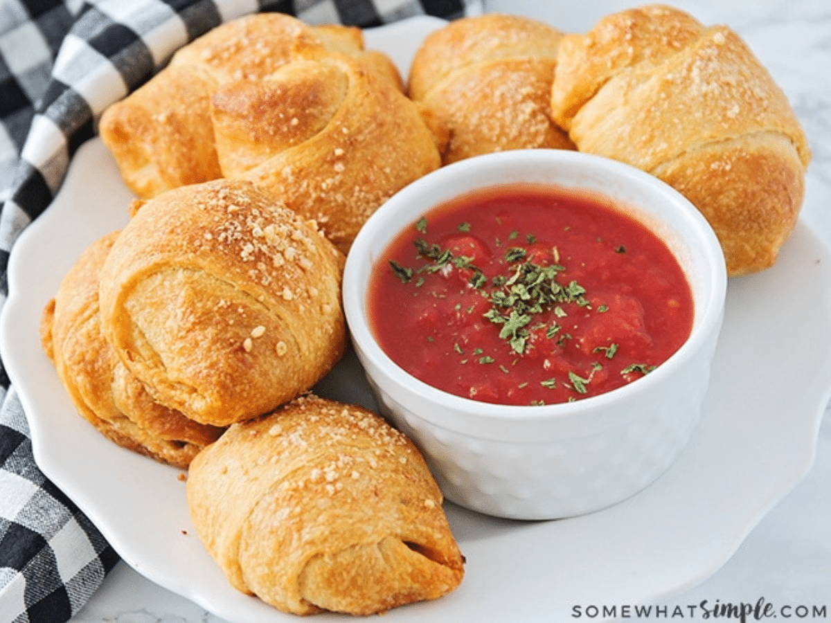 homemade pizza rolls plated with marinara sauce