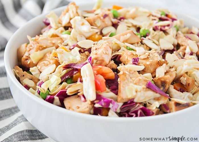 A close up of a white bowl filled with this easy Asian salad with chicken and vegetables