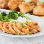 slices of teriyaki chicken with rice and broccoli
