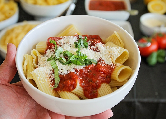 Host a fun and delicious dinner party at home with this easy Italian pasta bar! Mix and match pasta, sauce, and toppings to build the perfect bowl of pasta! 