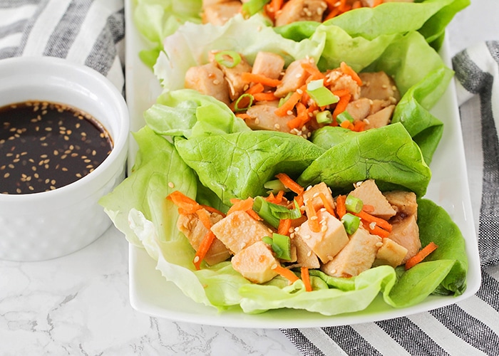 these easy chicken teriyaki lettuce wraps on a plate are a fun super bowl snack idea