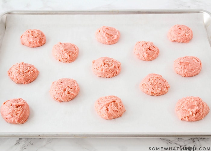 strawberry cake mix cookies recipe was used to create the batter for this tray of uncooked strawberry cake mix cookies