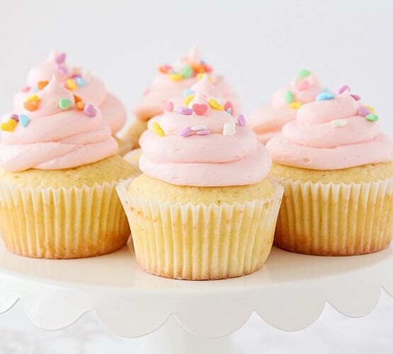 white cupcakes with pink frosting