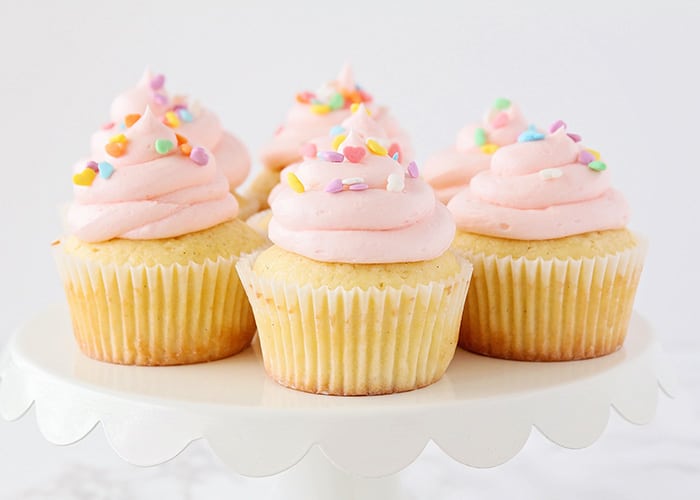 white cupcakes with pink frosting