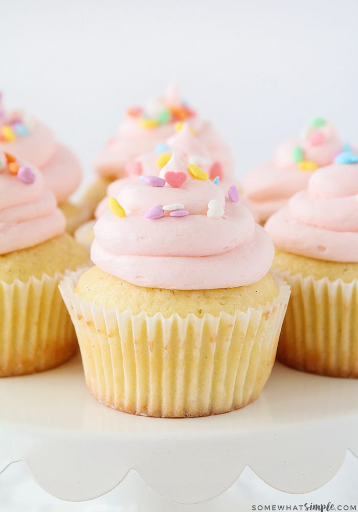 cupcakes topped with piped frosting and sprinkles