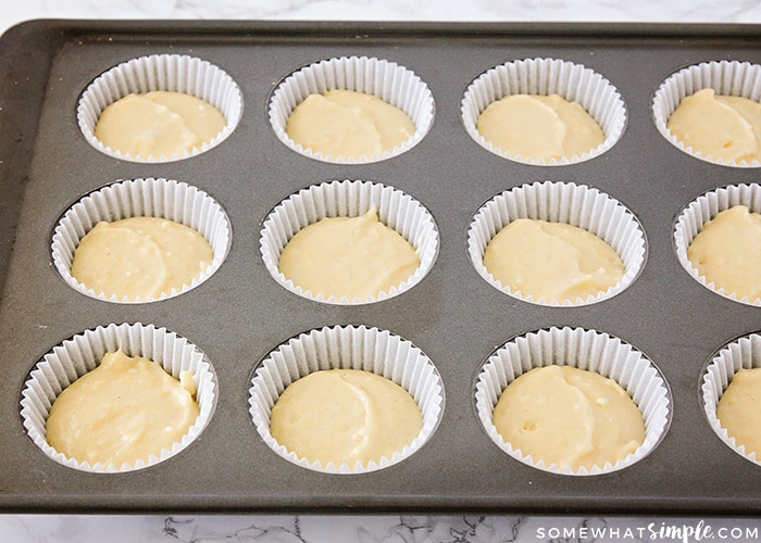 cupcake batter in a lined baking tin