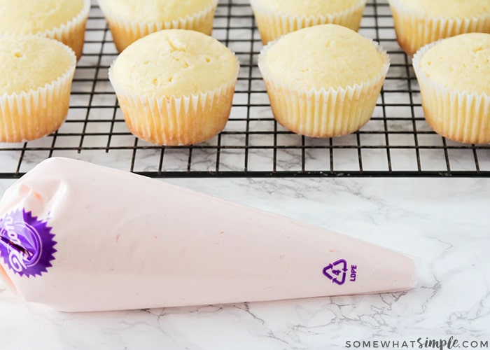 cupcakes next to a piping bag of frosting