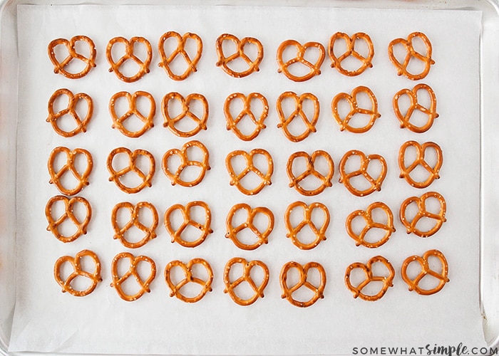 a baking tray full of pretzels in lines 