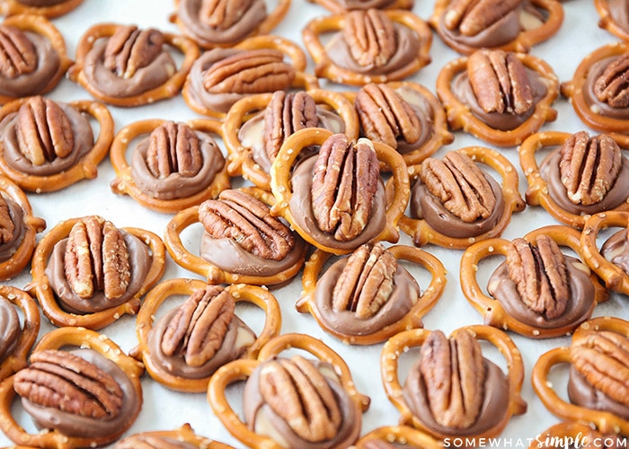 a tray full of baked pretzel rolo pecan turtles