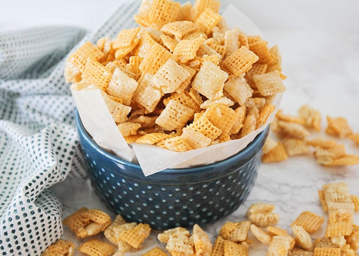 a blue bowl of homemade sweet Chex mix