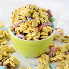 a bowl of zombie bait chex mix with sour gummy worms