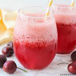 two glasses filled with a frozen cherry lemonade slush