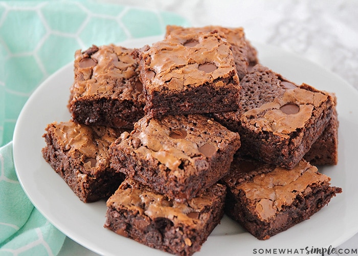 a white plate stacked high with fudgy homemade brownies