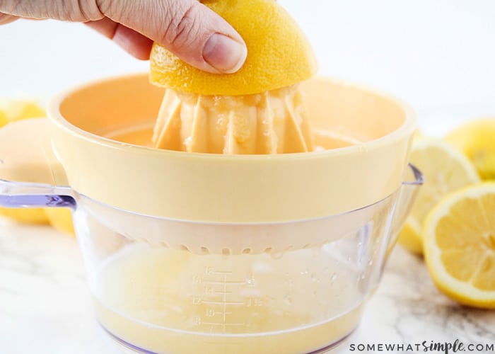 a lemon being squeezed for the juice