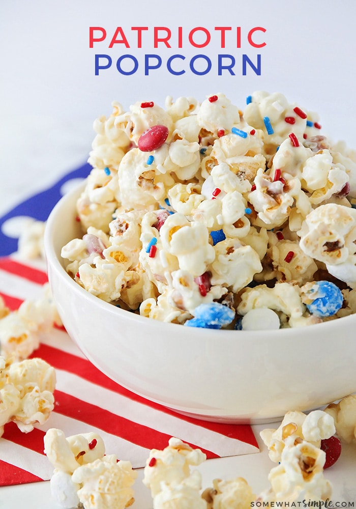 This patriotic popcorn is a simple white chocolate popcorn recipe that's packed with little bites of milk chocolatey goodness! With it's red, white and blue colors, it's a festive snack or dessert for Memorial Day, the 4th of July or any other patriotic occasion. #patrioticpopcornrecipe #whitechocolatepopcorn #redwhitebluepopcorn #july4thdessert #memorialdaydessert via @somewhatsimple