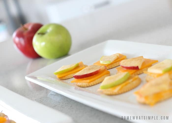 a tray with Apple Cracker and cheese snacks Snacks