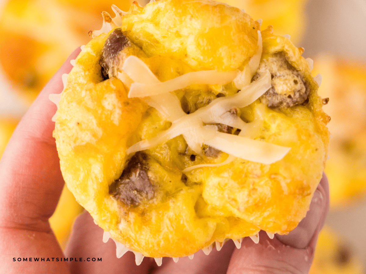 close up of a hand holding a breakfast cupcake
