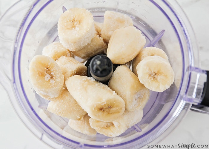 looking down on a blender filled with chopped frozen bananas