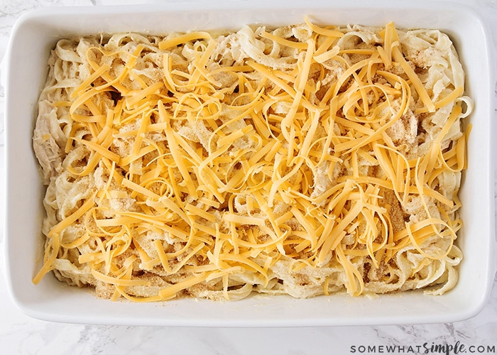 casserole pan filled with chicken tetrazzini covered with cheese ready to be baked in the oven