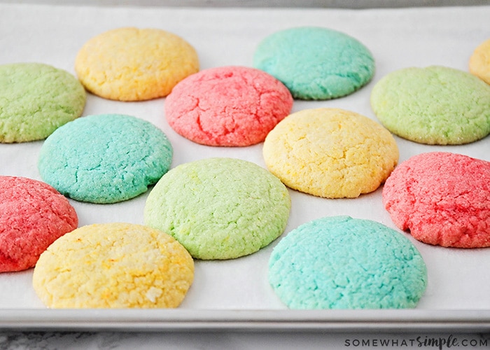 a baking sheet of colorful red, blue, yellow and green cookies made with Jello using this easy recipe