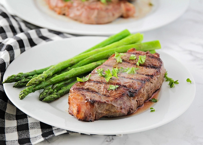 plated steak next to aspaaragus