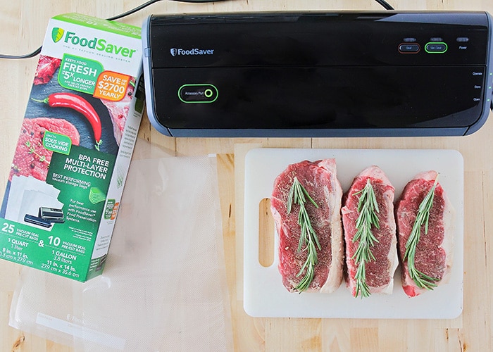 cuts of meat with next to a food saver machine