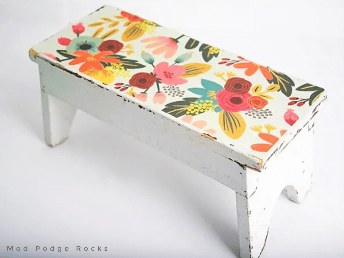 little wooden stool covered in scrapbook paper