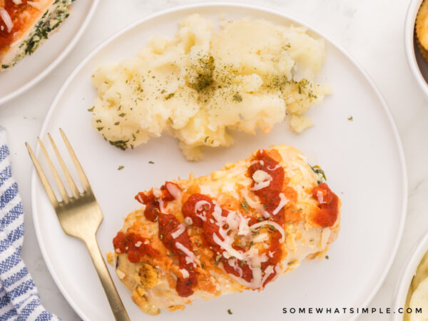 plated chicken parmesan next to mashed potatoes