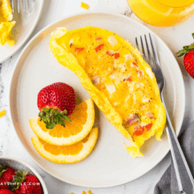 plated Omelets in a Bag with sliced fruit
