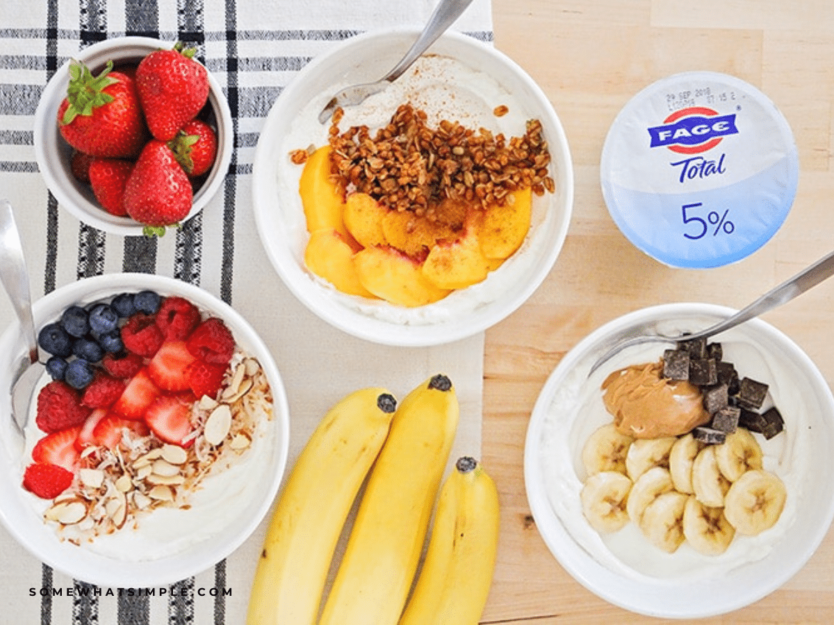 Yogurt parfaits set up on a table next to supplies