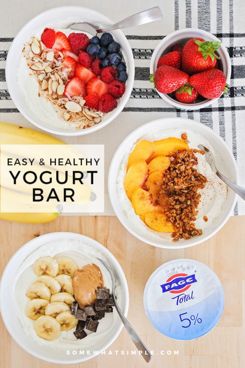 overhead shot of 3 yogurt parfaits with ingredients for a yogurt bar