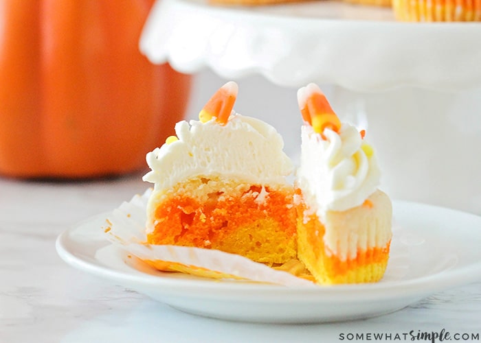 a candy corn cupcake cut in half so you can see the colorful layers