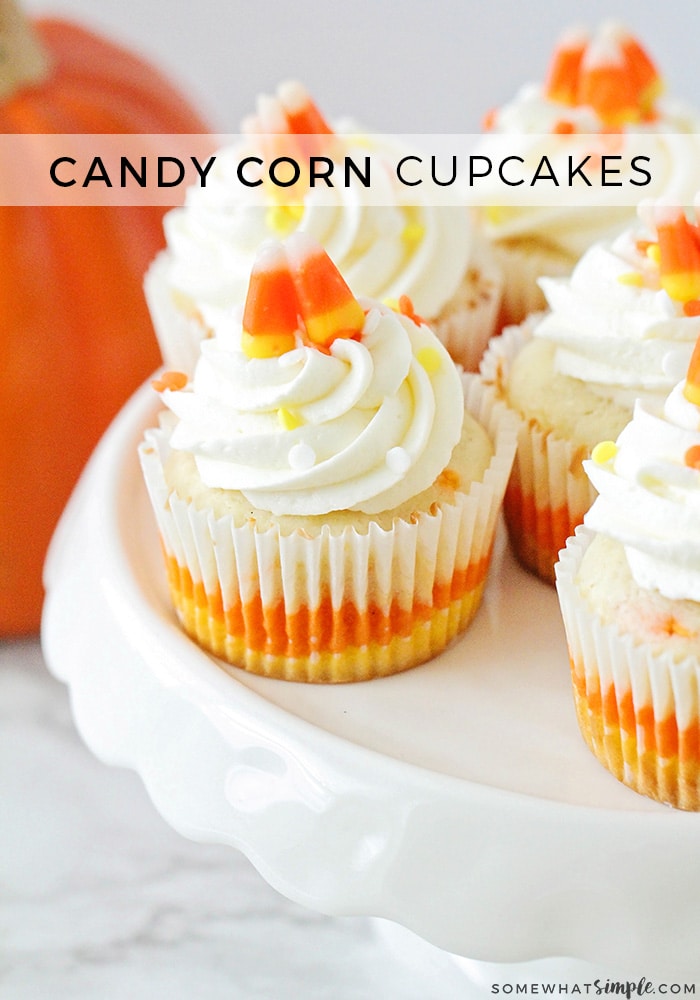 Candy corn cupcakes are a delicious treat that are adorably festive and super easy to make!  Those yellow, orange and white colors just scream Fall! The cupcakes are perfect to serve at a Halloween party or any fall event. via @somewhatsimple