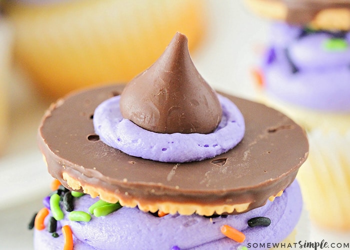 a close up of the witch hat that's made with a cookie, frosting and a Hershey's kiss that's place on top of a cupcake