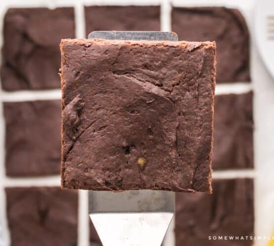 1 square protein brownie on a spatula above the pan of brownies
