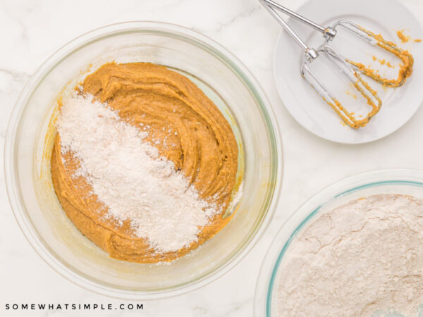 adding dry ingredients to the wet cookie ingredients