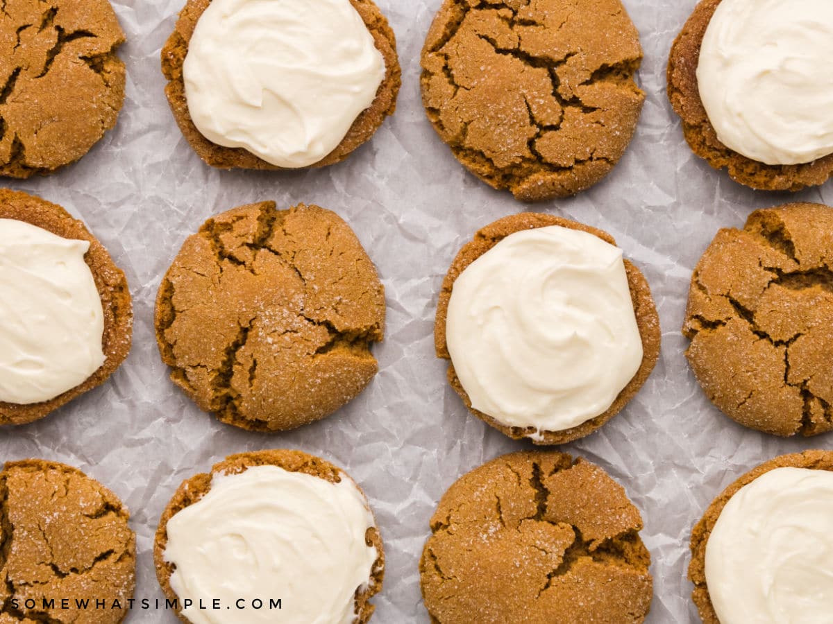 adding frosting onto ginger sandwich cookies 