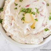 bowl of mashed potatoes with butter and herbs