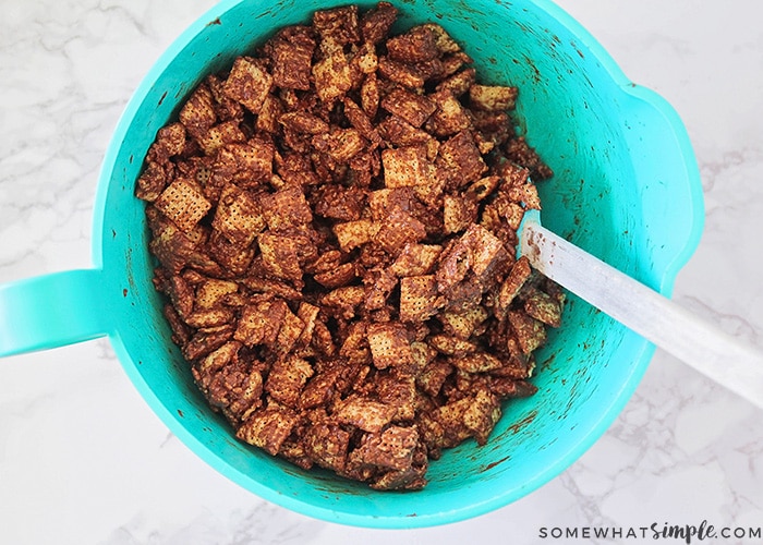 a bowl with chocolate covered chex mix that has been well stirred