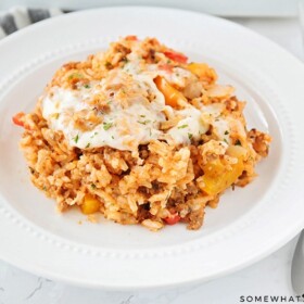 stuffed pepper casserole on a white plate with a fork next to the plate