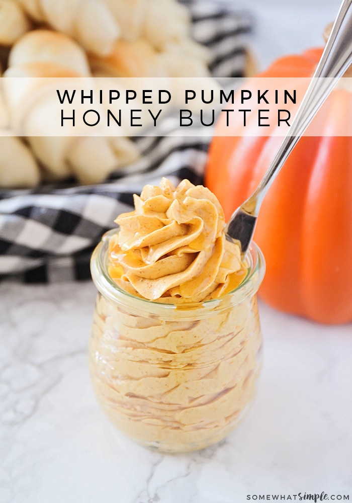 a close up of a jar of whipped pumpkin honey butter with a butter knife in the jar