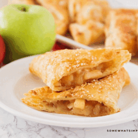 Apple Turnovers plated and cut in half, showing the apple cinnamon inside