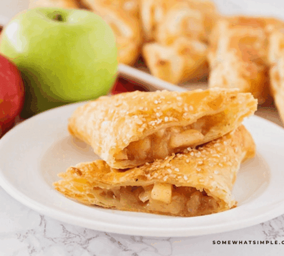 Apple Turnovers plated and cut in half, showing the apple cinnamon inside